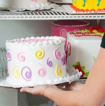 Adding birthday cake to refrigerator.