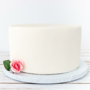 White cake covered with fondant and roses.