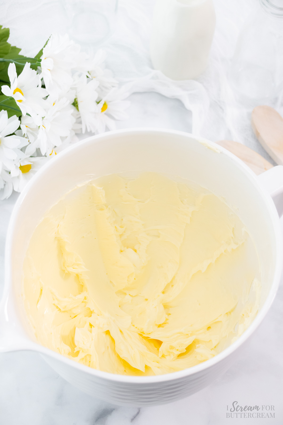 Mixed butter in a white mixing bowl.