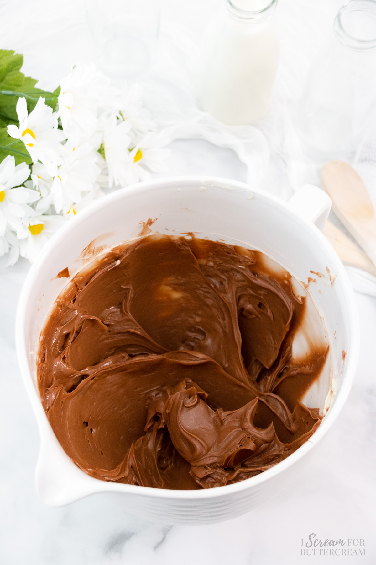 Chocolate with butter mixed in a large mixing bowl.