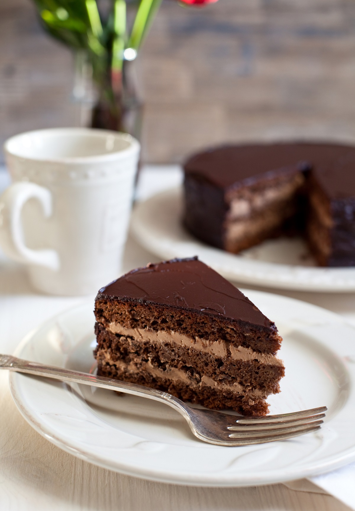 Chocolate mouse cake on a white plate.