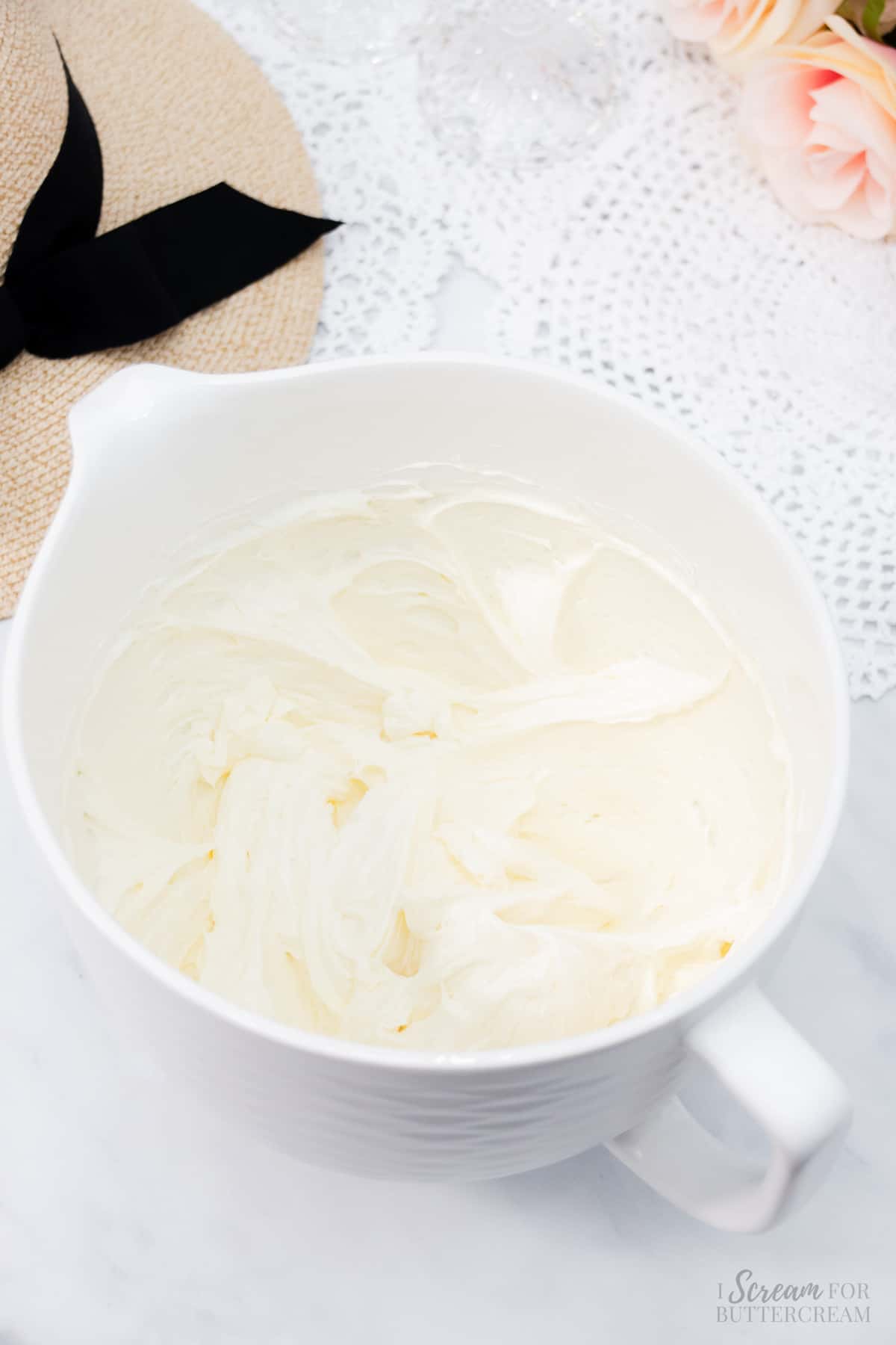 Cream cheese frosting in a white mixing bowl.
