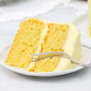 Featured image with lemon cake on a white plate with a fork.