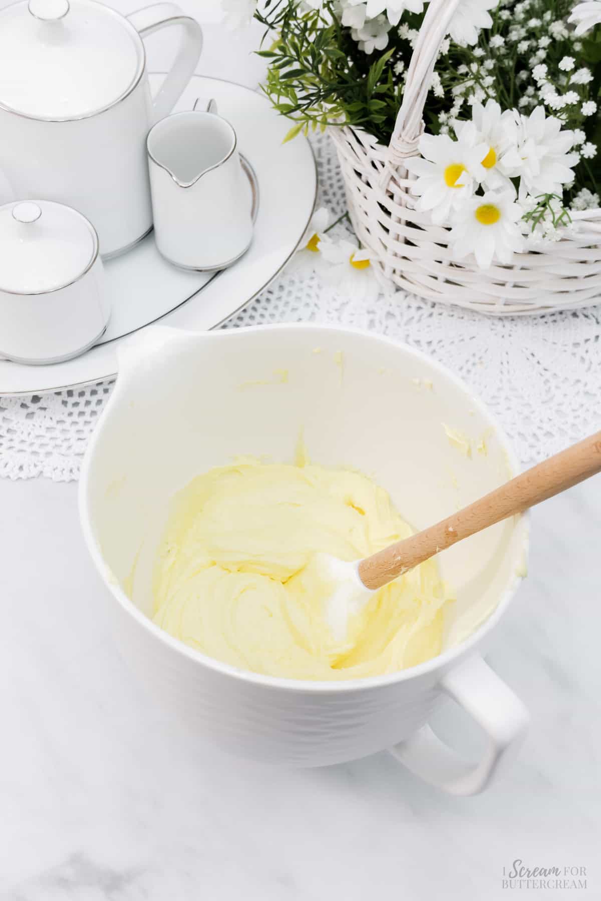 Lemon buttercream in a large white mixing bowl.
