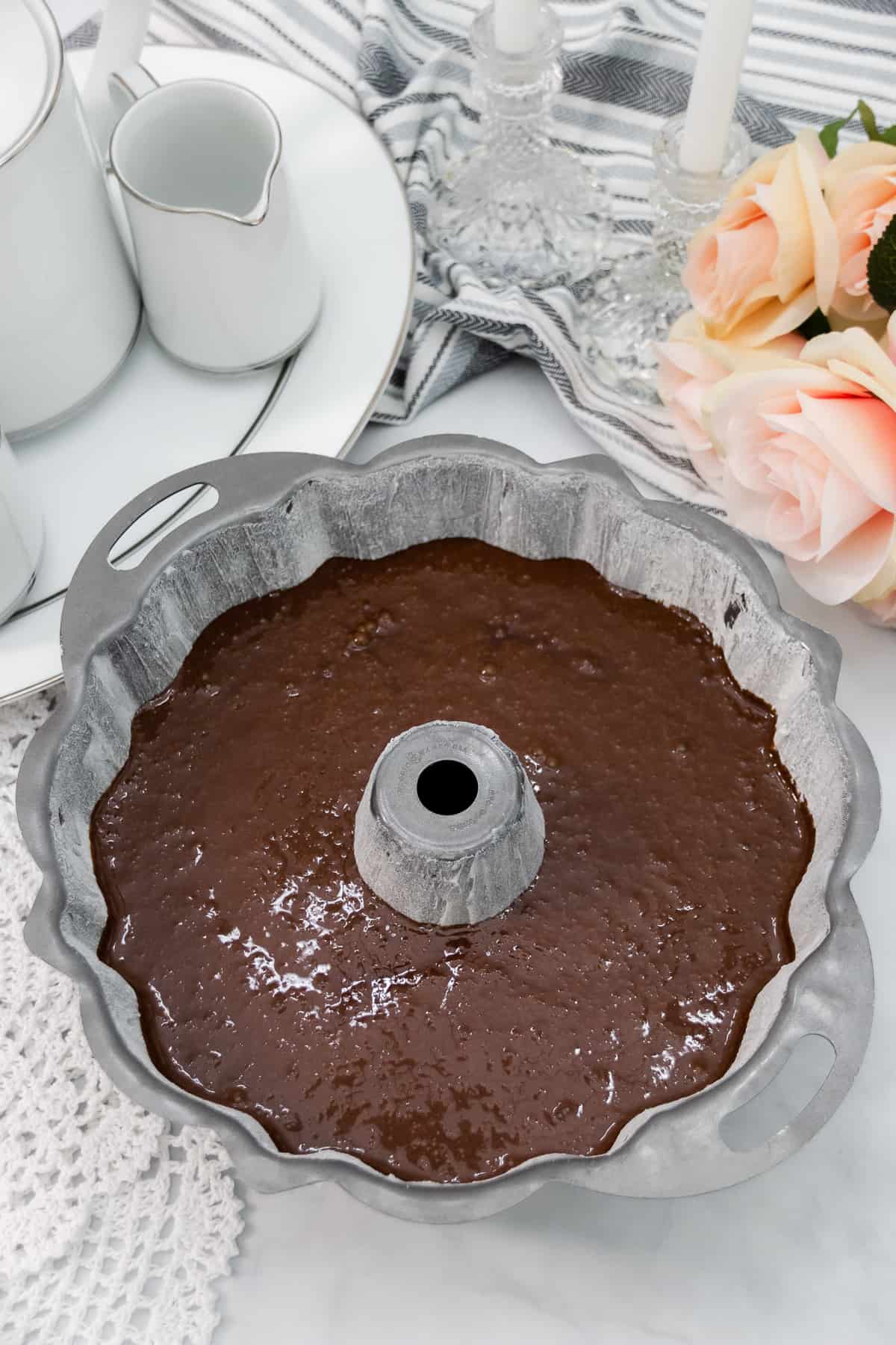 Chocolate pound cake batter poured into a large bundt pan.