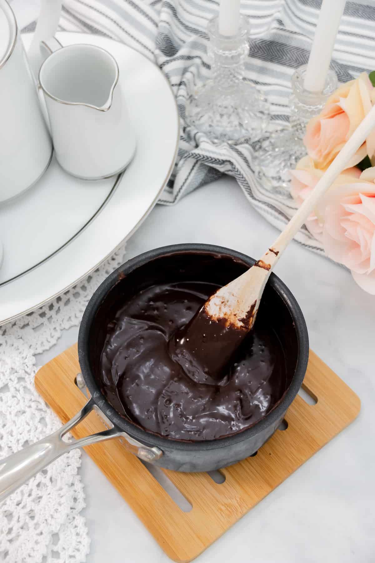 Chocolate glaze in a saucepan.