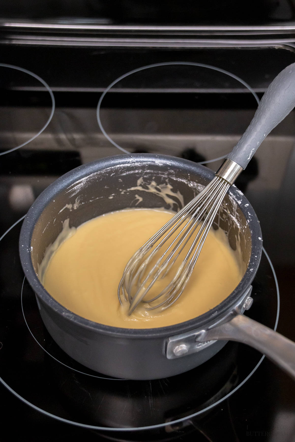 Buttermilk glaze cooling in a saucepan.