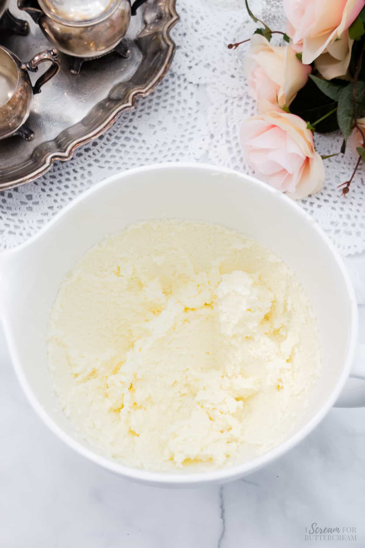 Whipped butter and sugar in a mixing bowl.