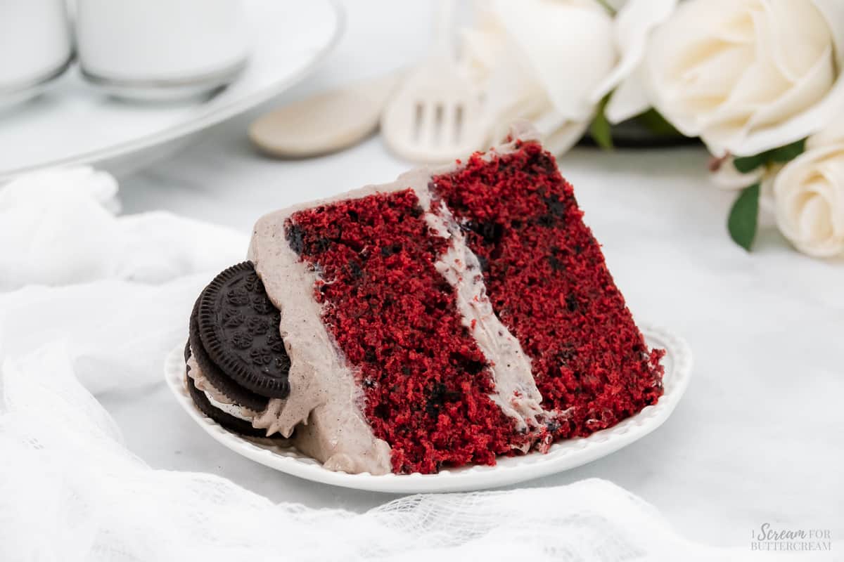 Slice of oreo red velvet cake on a white plate.