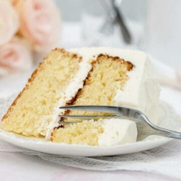 Close up image of easy vanilla cake on a plate with a fork.