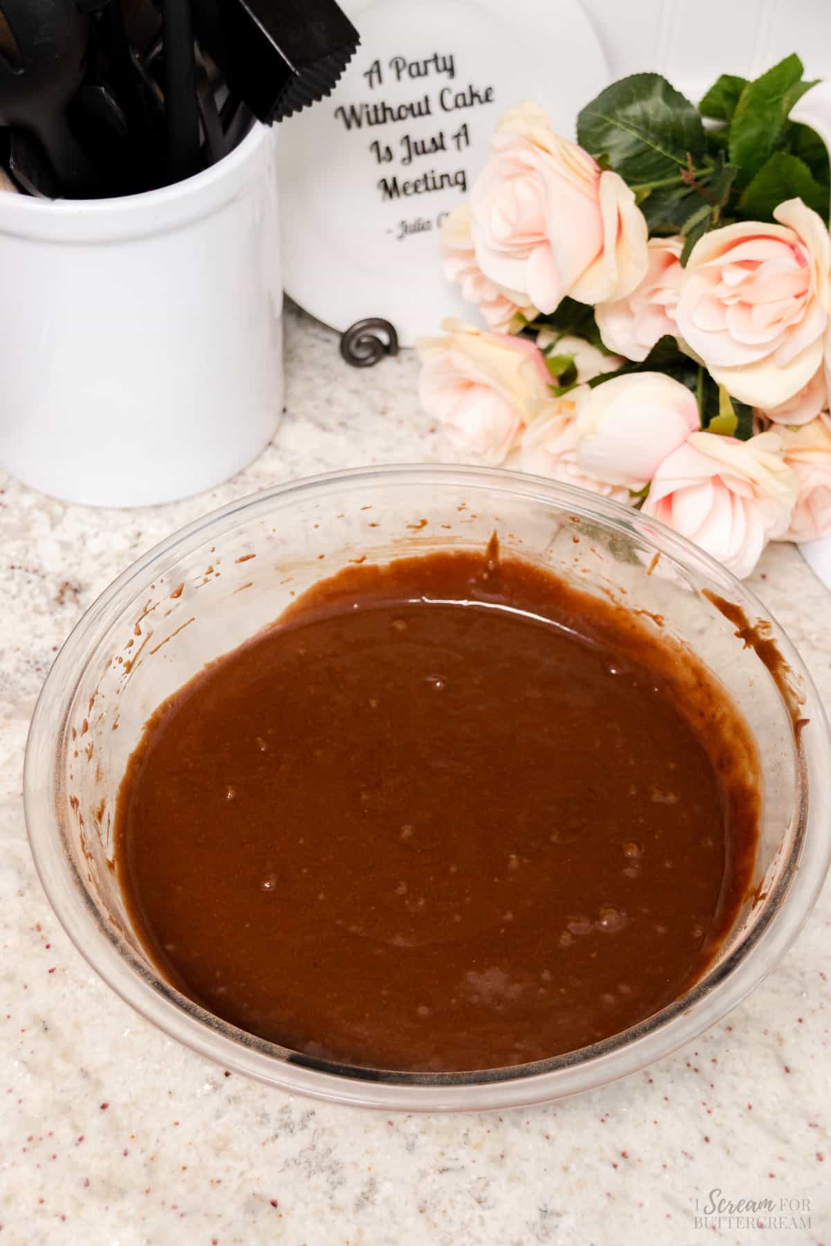 Mixed chocolate and coconut cake batter in a glass mixing bowl.