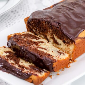 Featured image of marble cake sliced on a plate.