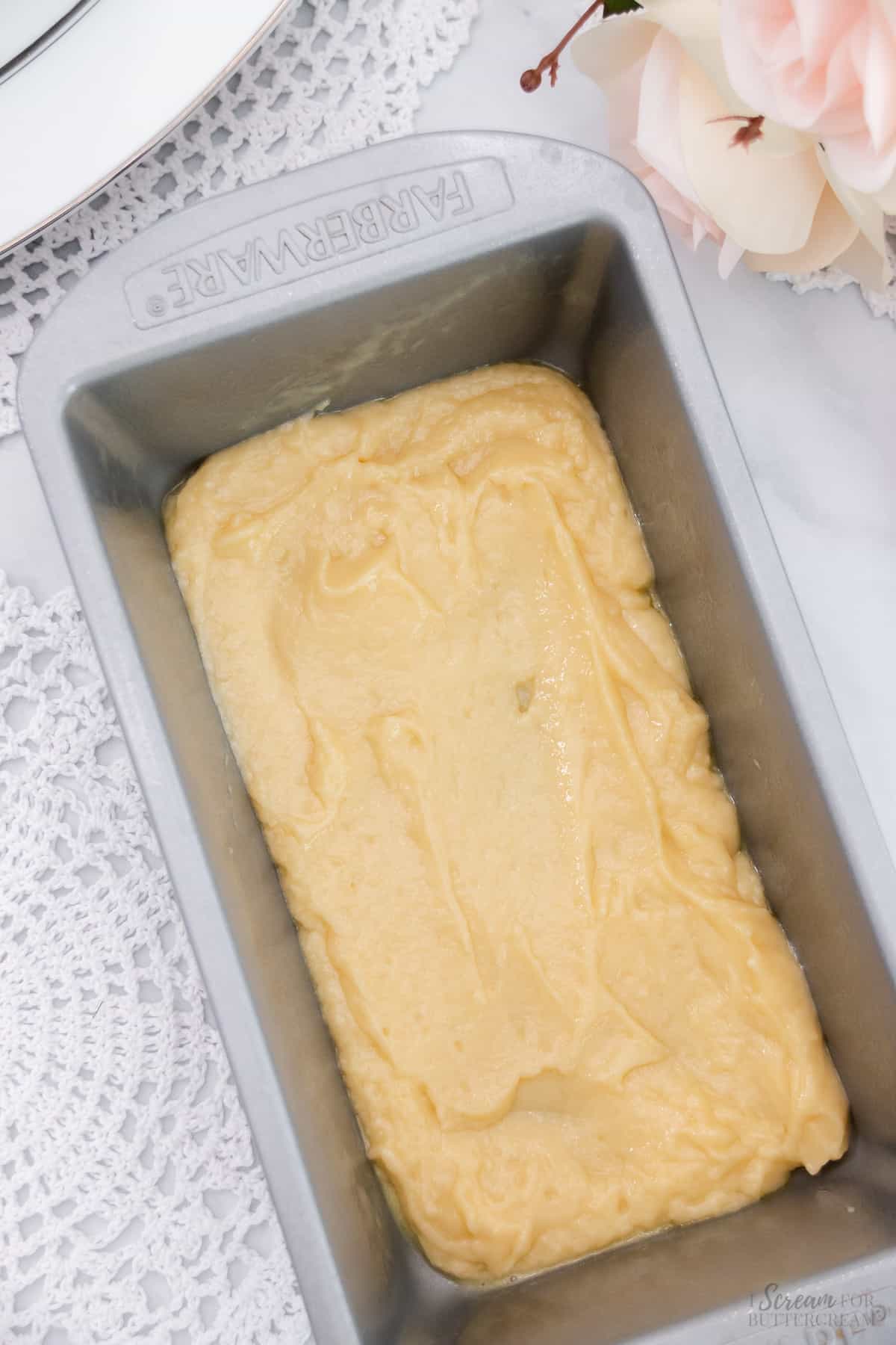 Small amount of vanilla cake batter in the bottom of a loaf pan.