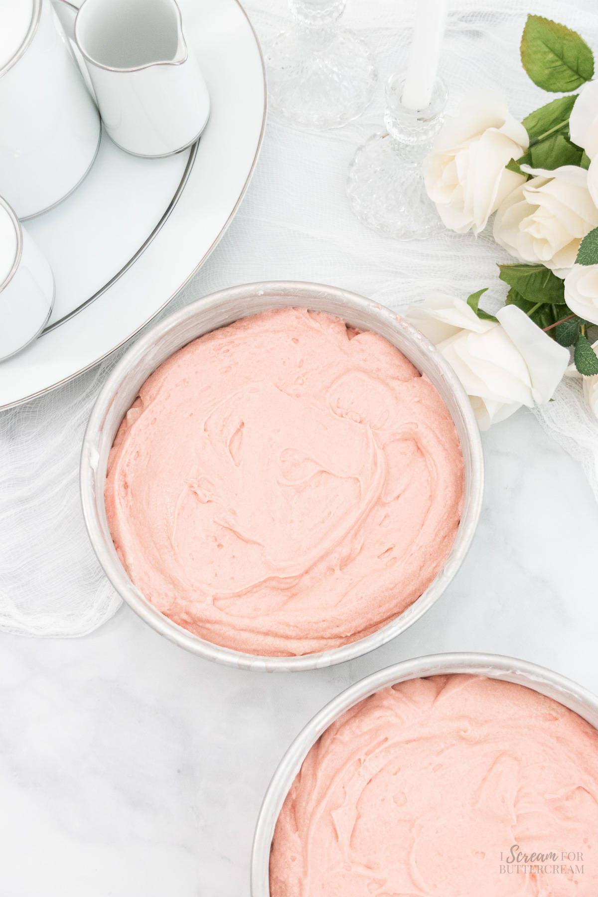 Strawberry cake batter in two round cake pans.