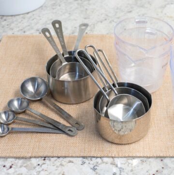 Silver and liquid measuring cups on a counter top.