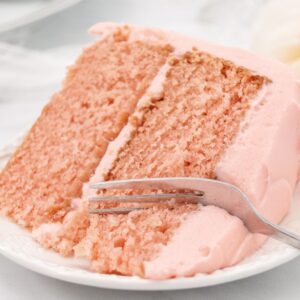 Close up of strawberry cake with fork in it.