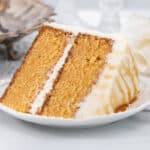 Large slice of caramel cake on a white plate.