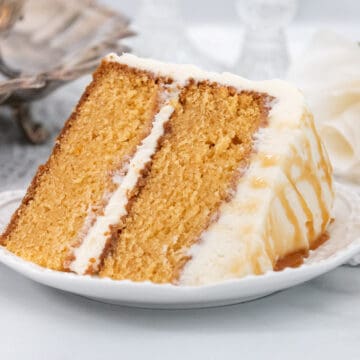 Large slice of caramel cake on a white plate.