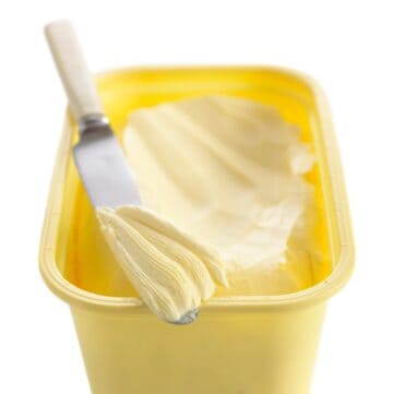 Tub of margarine with knife.