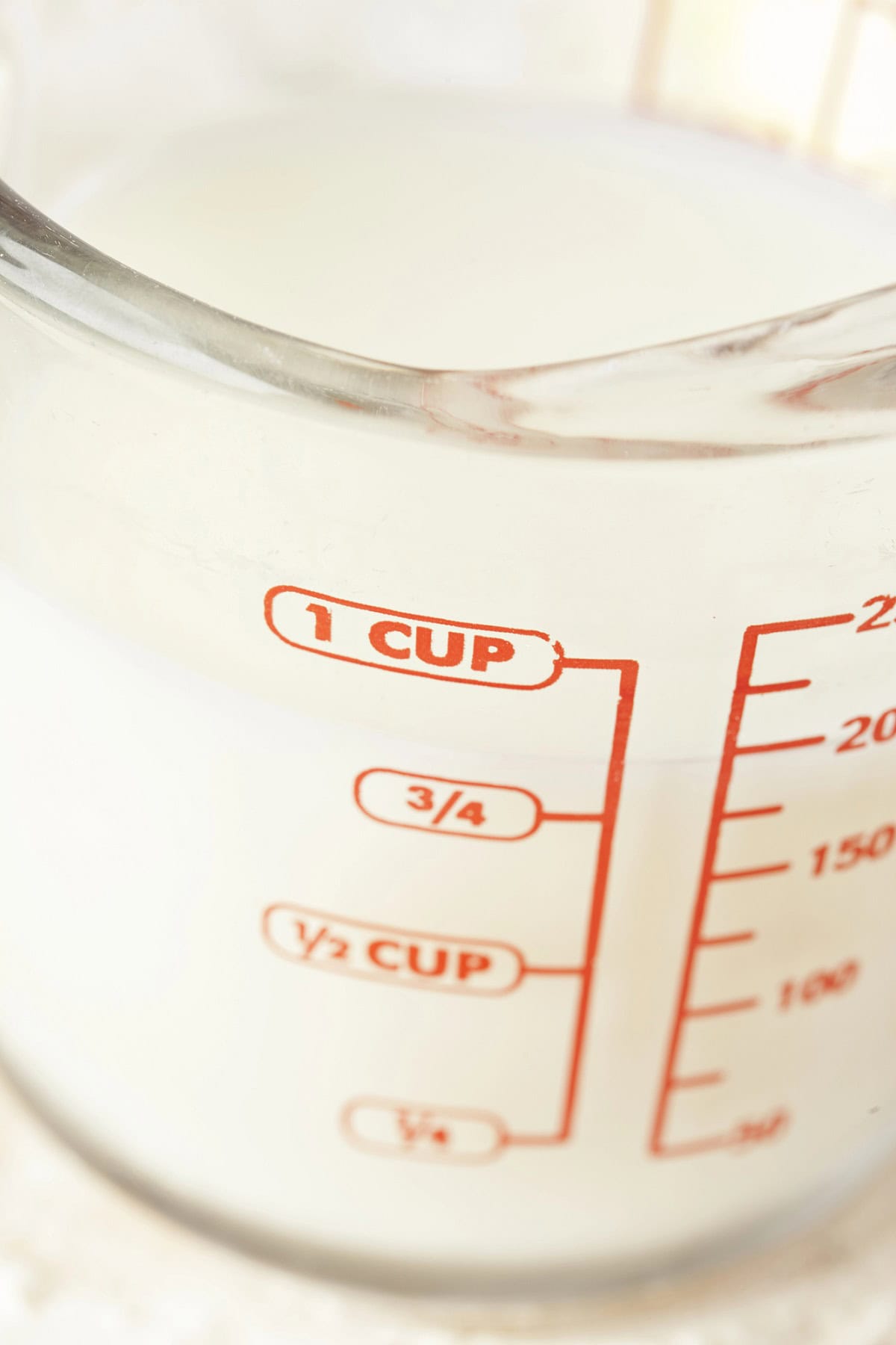 Measuring cup with milk.