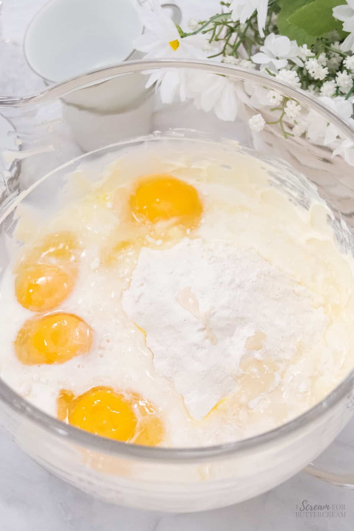 Cake batter ingredients in a glass mixing bowl.