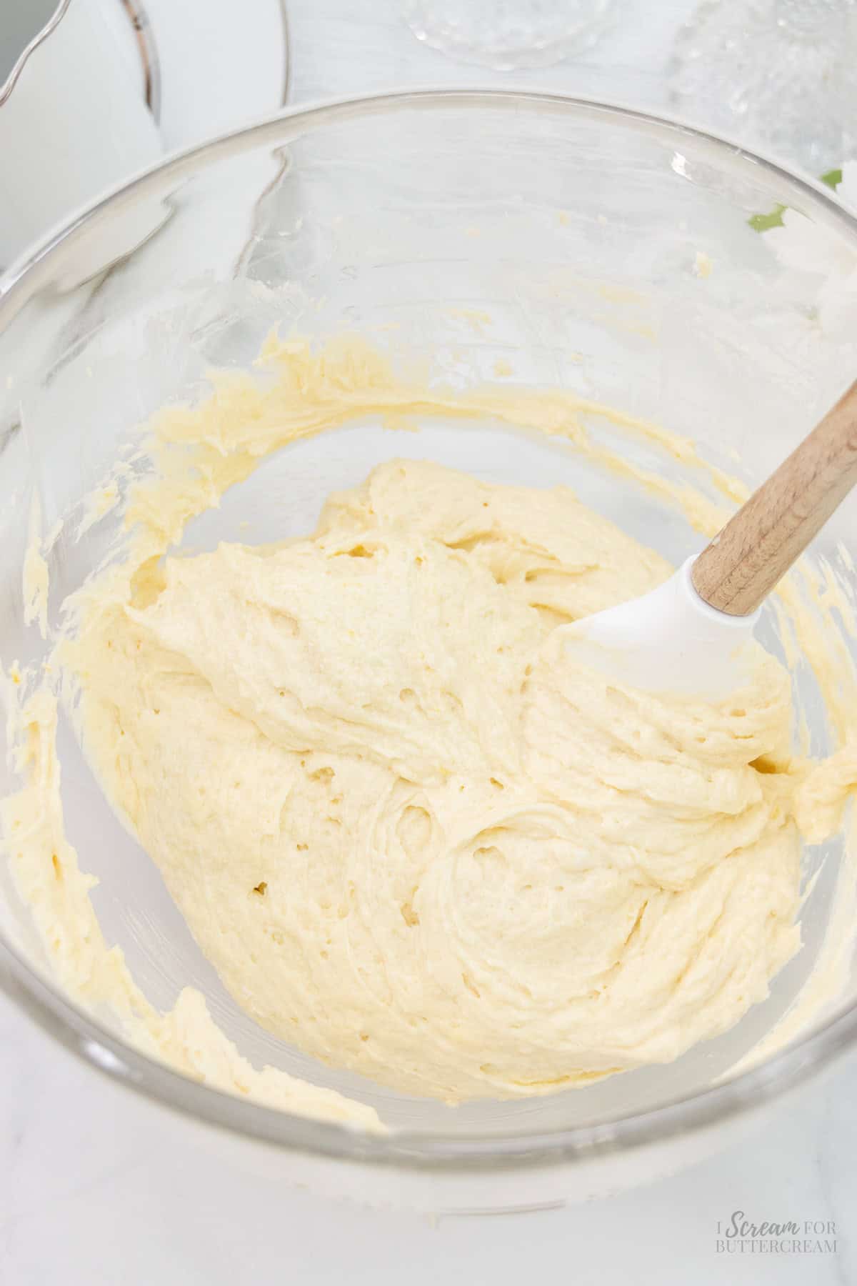 Mixed cake batter in a glass bowl.