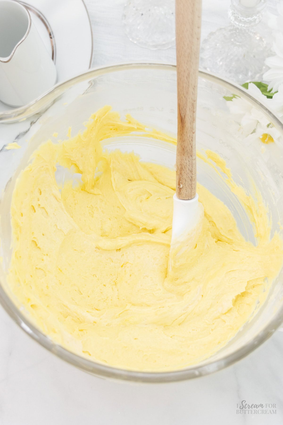 Lemon cake batter mixed in a glass bowl.