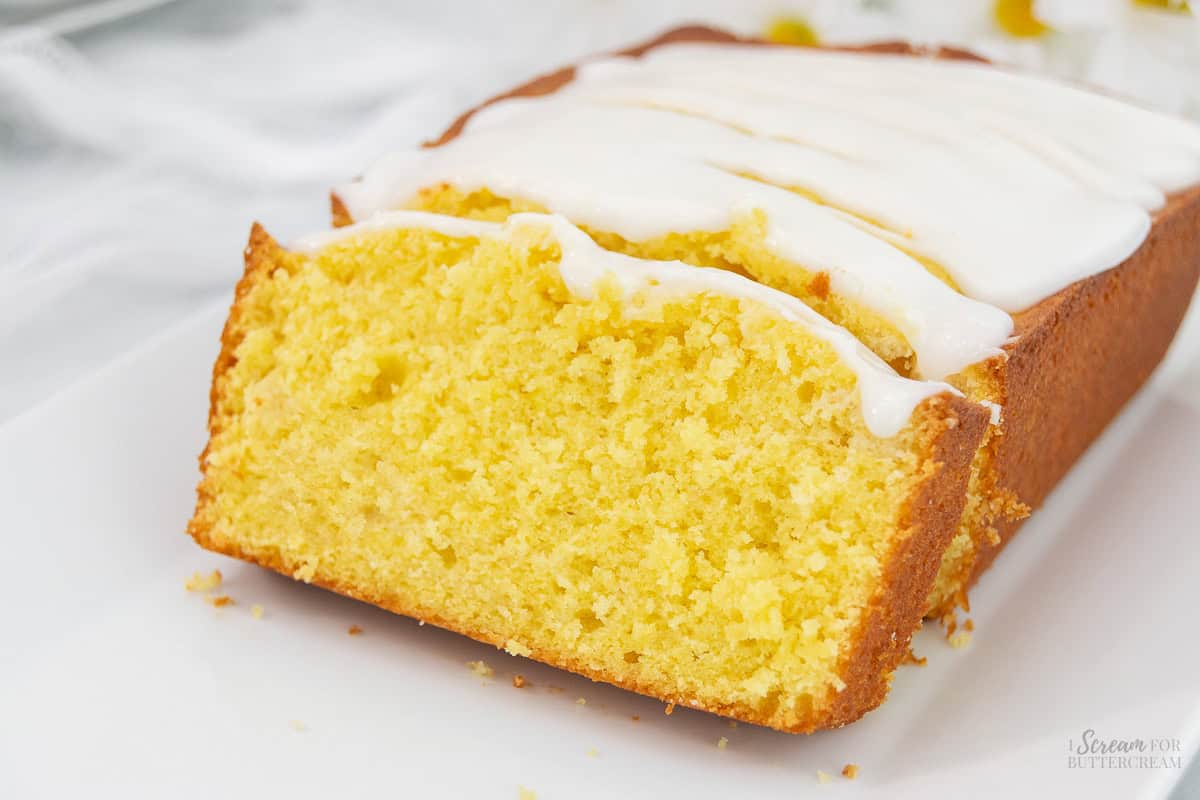 Close up of sliced lemon pound cake on a white platter.