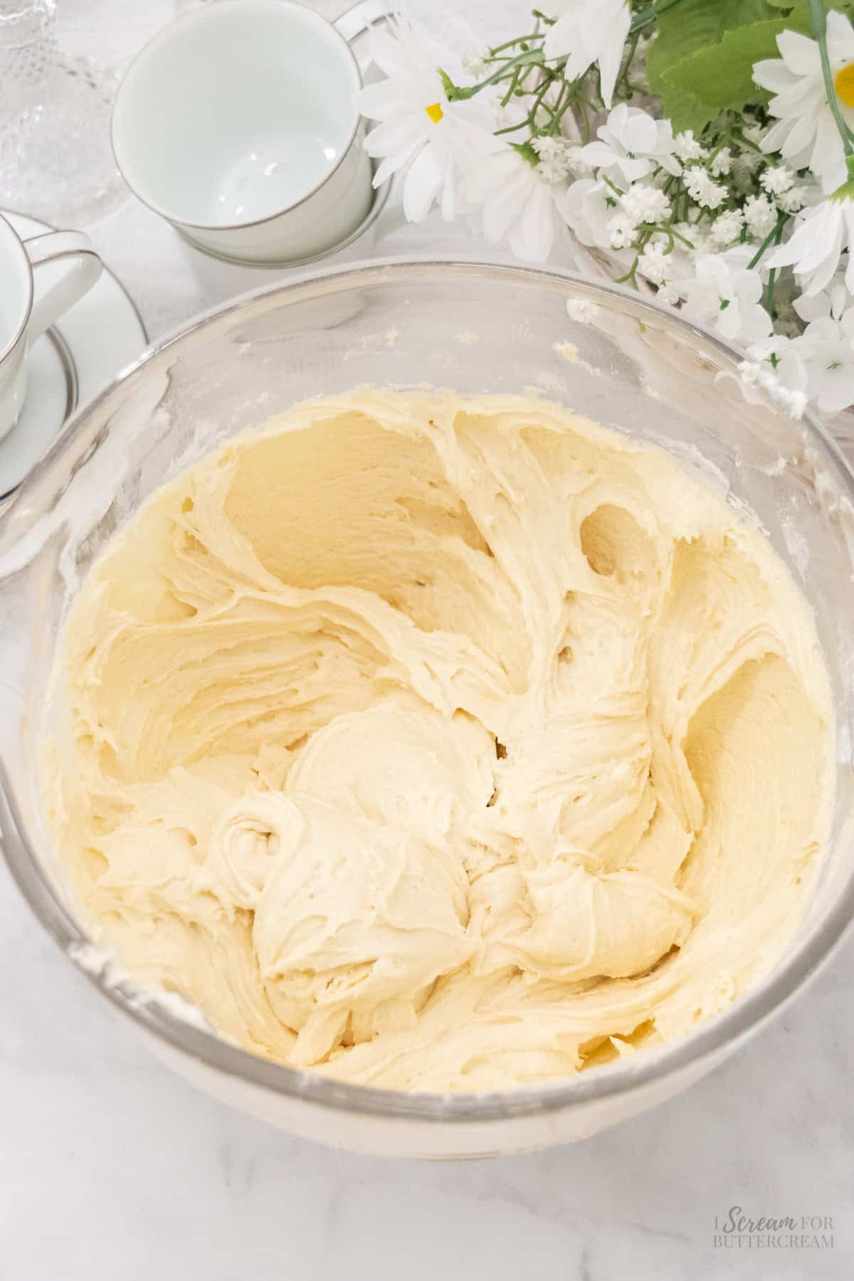 Cake batter mixed in a glass mixing bowl.