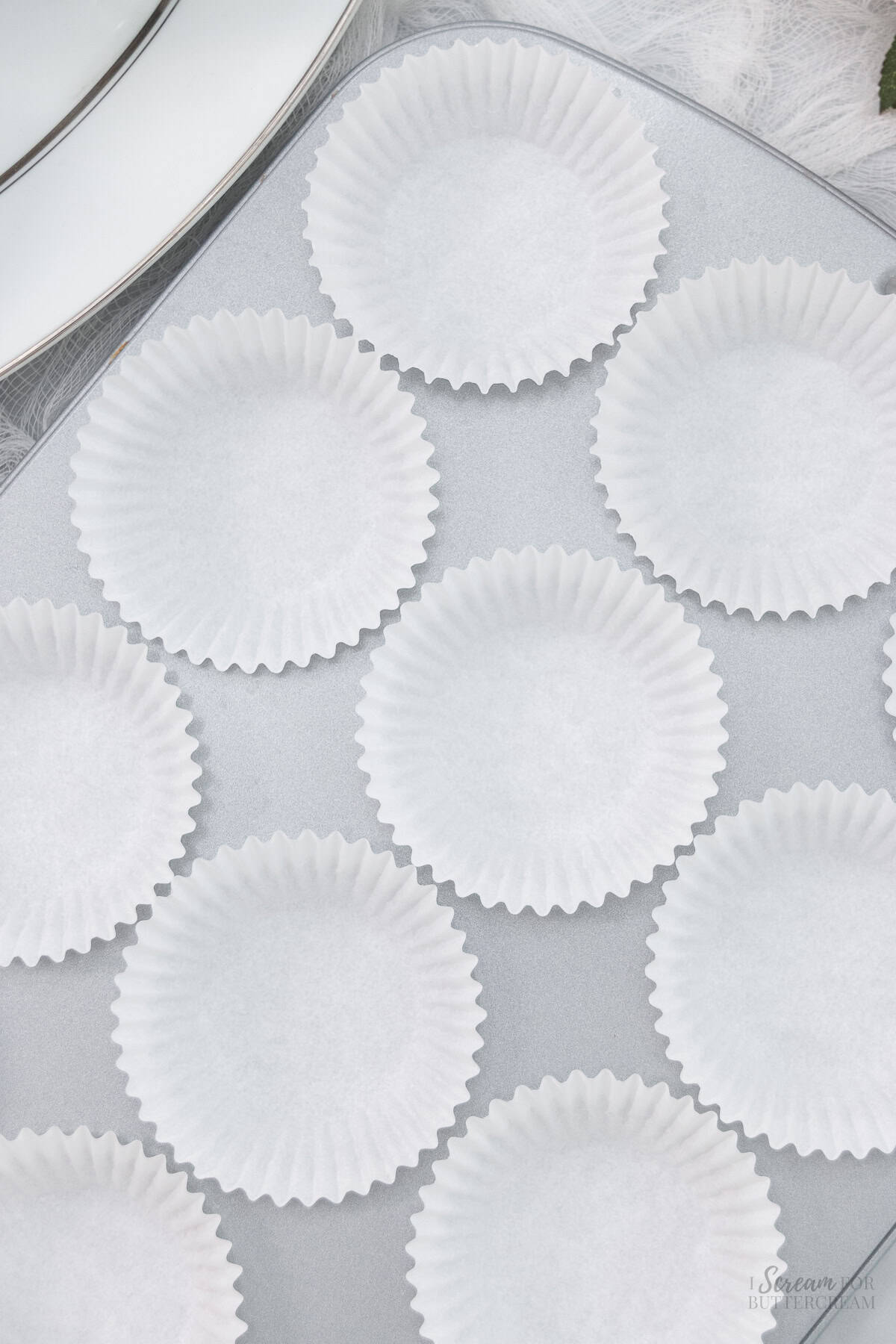 Top down view of cupcake liners in a cupcake pan.