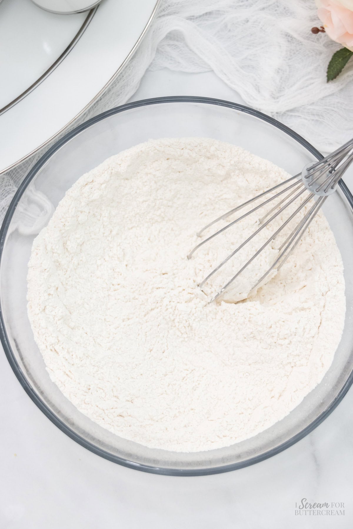 Dry vanilla cupcake ingredients in a glass bowl.