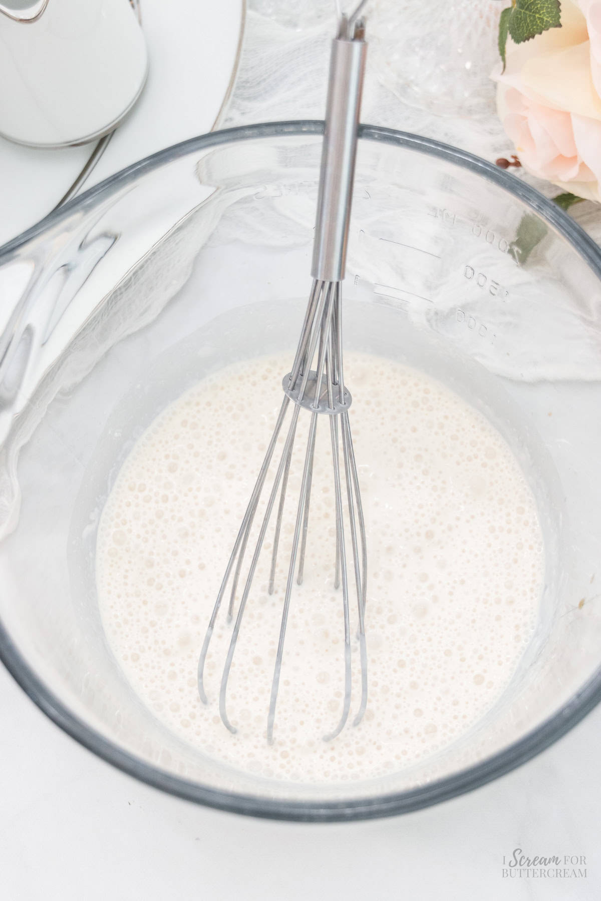 Liquid vanilla cupcake ingredients in a glass bowl.