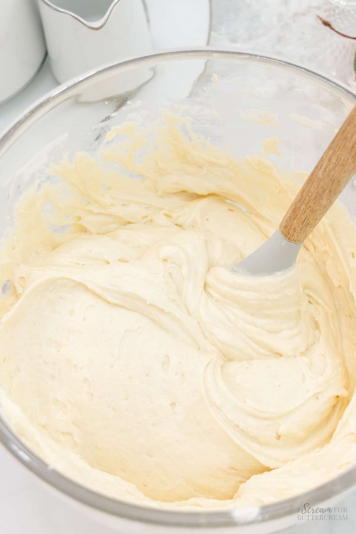 Mixed vanilla sour cream cupcake batter in a glass pan.