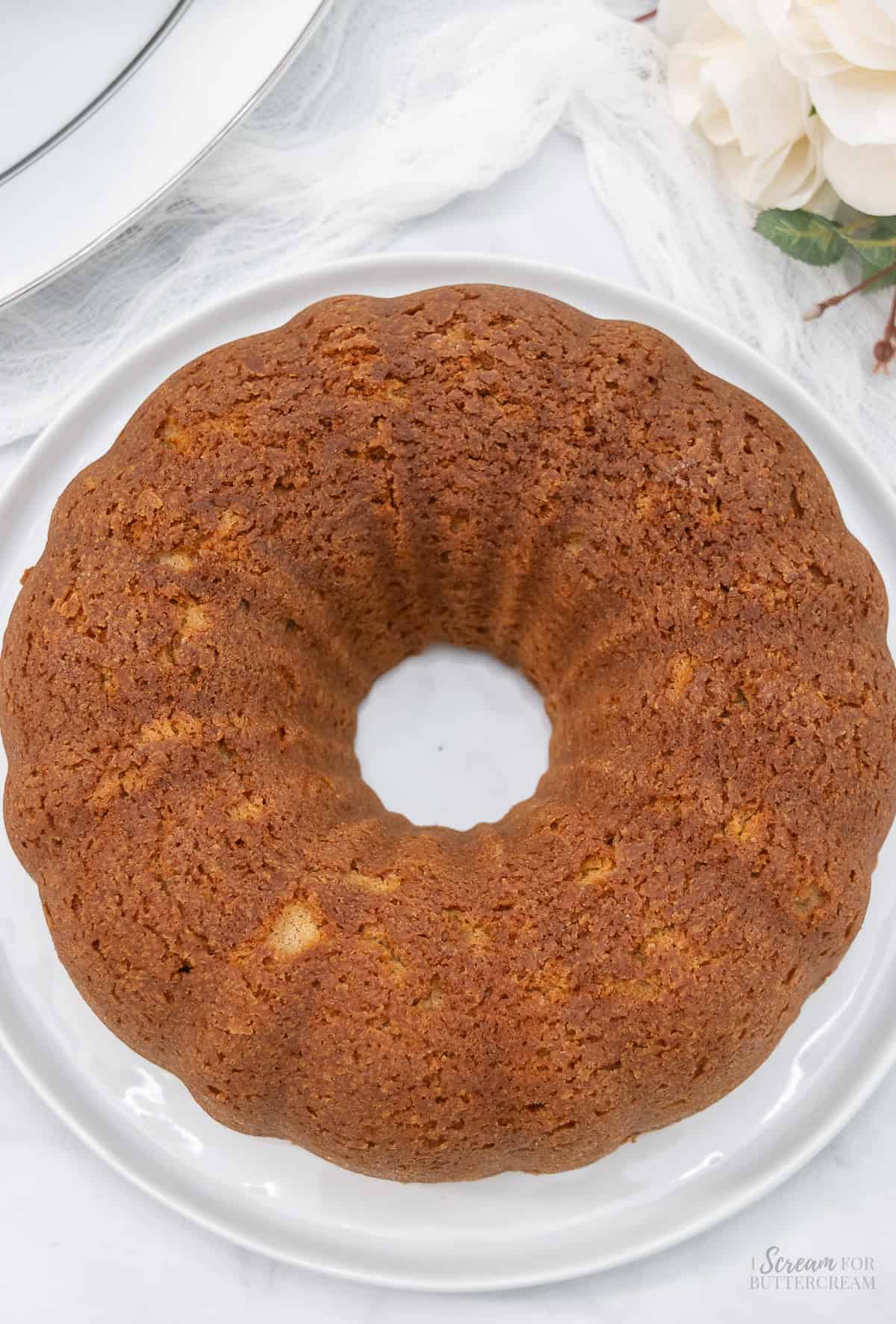 Top view of spice bundt cake without glaze on a white platter.