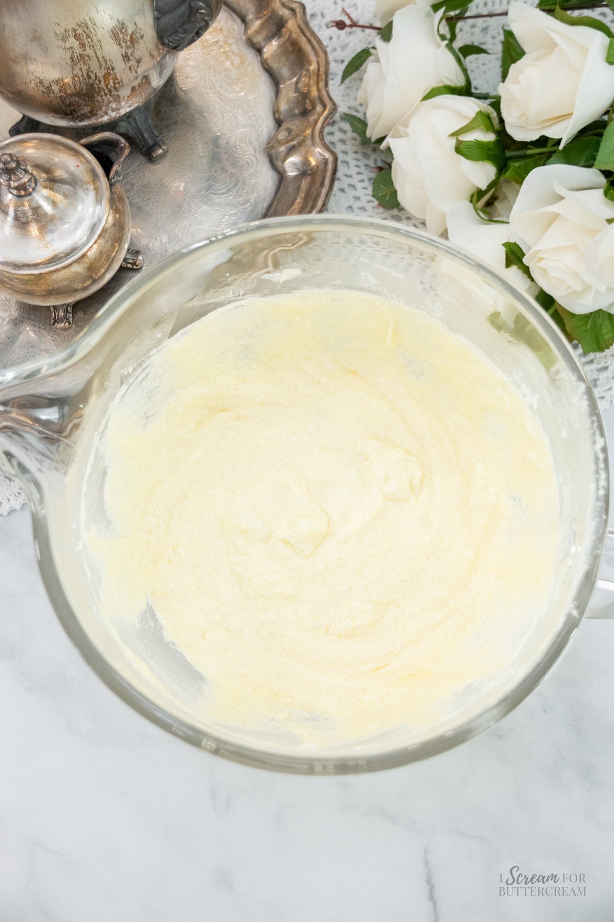Glass bowl filled with mixed liquid cake ingredients, ready to mix with dry ingredients.
