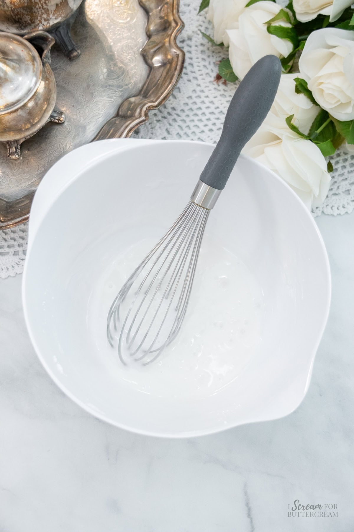 White mixing bowl with freshly whisked glaze.