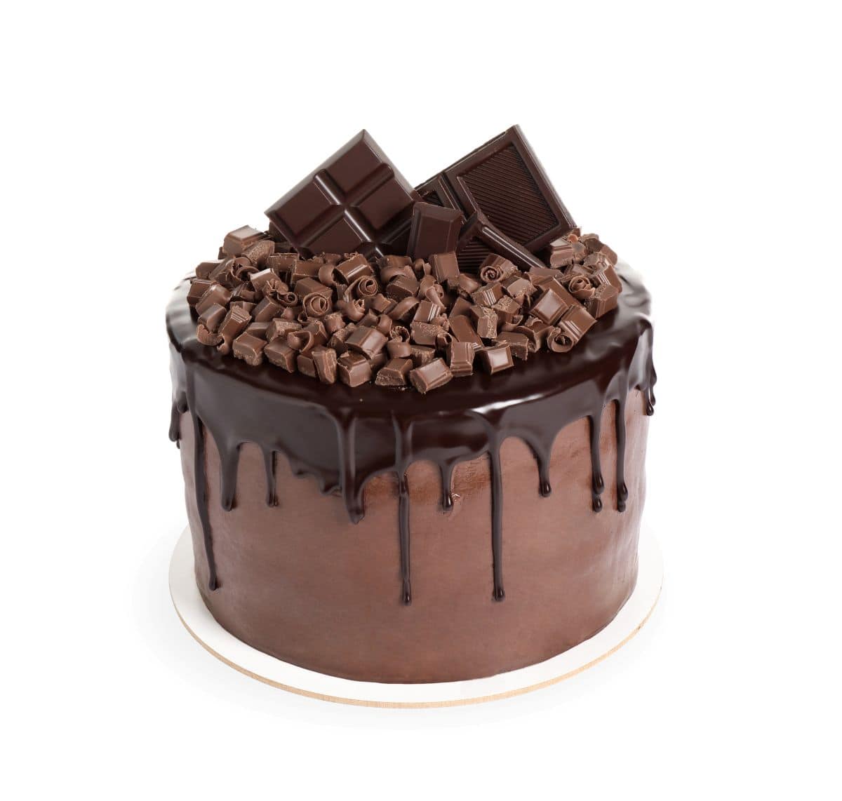 A rich chocolate cake covered in smooth chocolate frosting and topped with a glossy dark chocolate ganache drip. The top is piled high with a mix of chocolate curls, chunks, and bars for an ultra-decadent finish. Displayed on a simple white cake board against a clean white background.